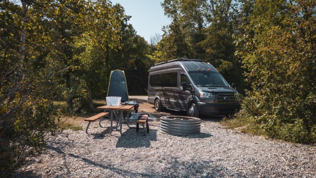 van next to a shower and a picnic table