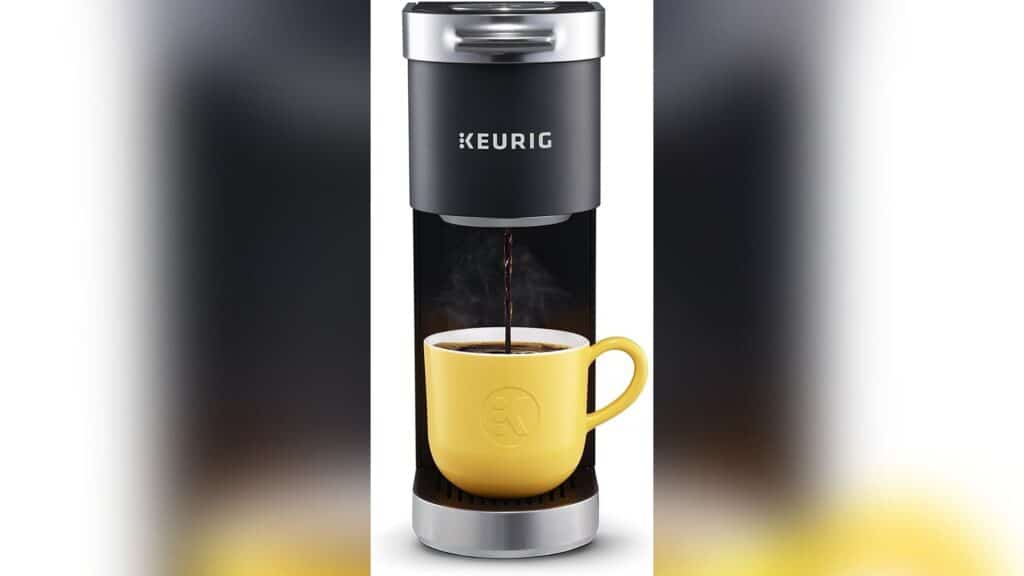 Keurig Mini making a cup of coffee. The coffee cup in the picture is yellow.