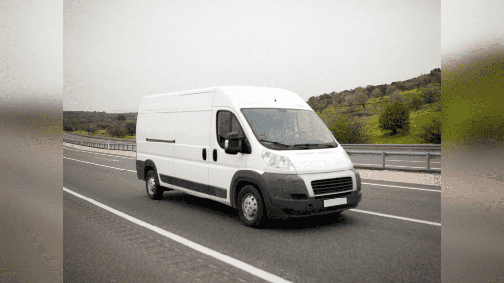 White RAM ProMaster cargo van driving down the road